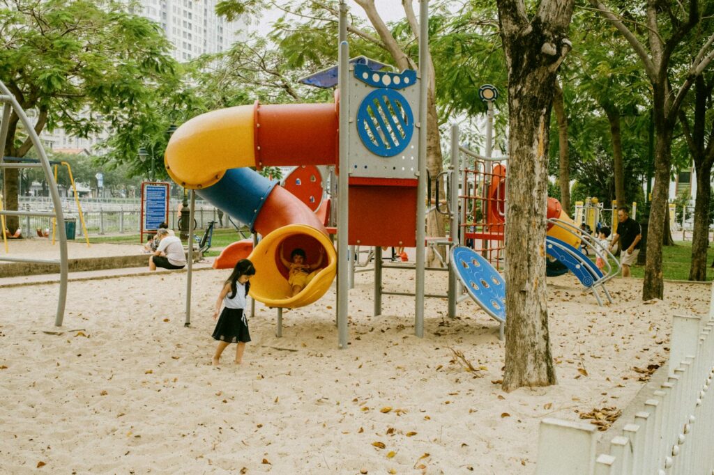 Family enjoying an outdoor park and playground in Shanghai with children