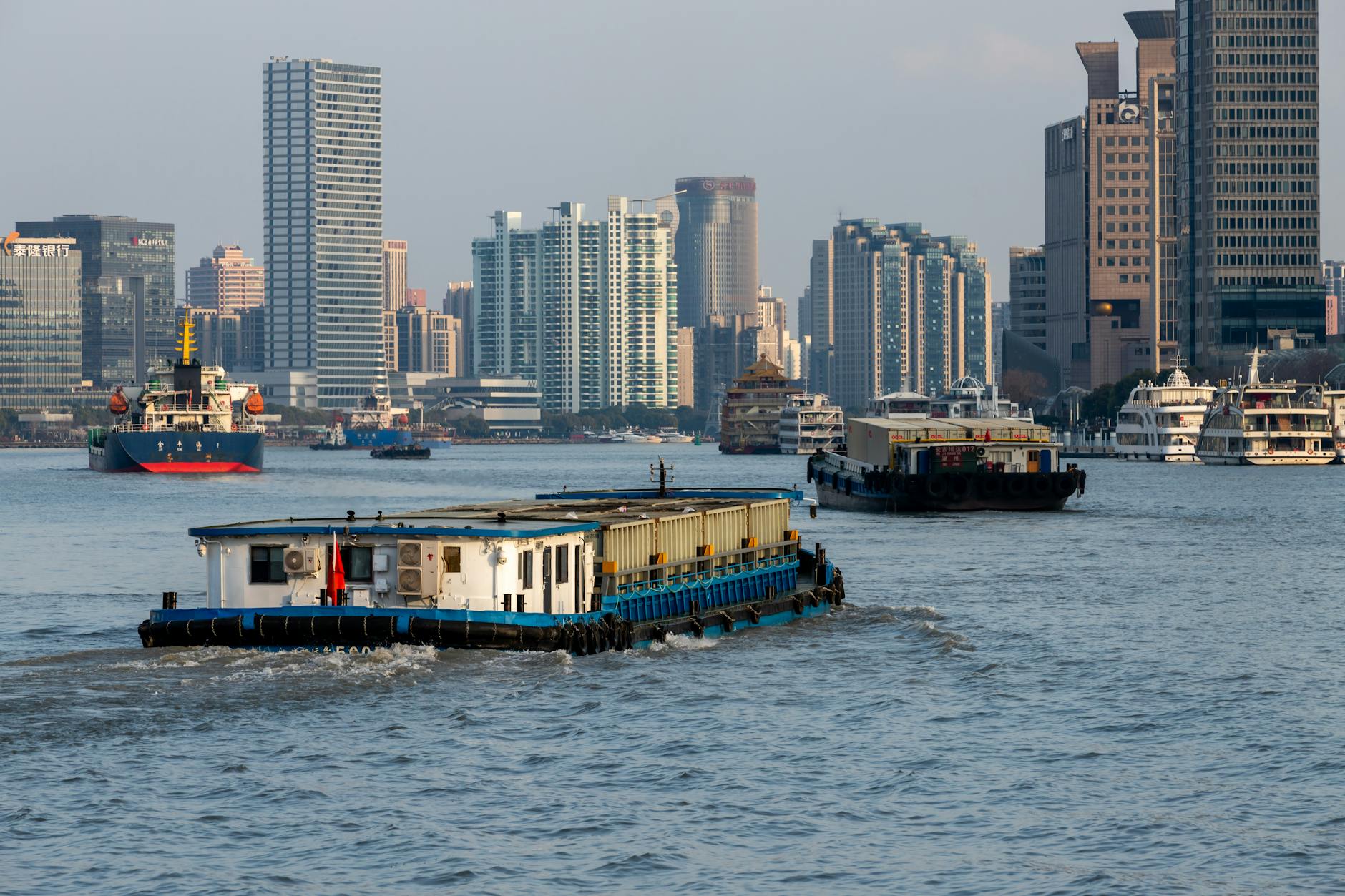 Huangpu River in Shanghai with boats and waterfront city views