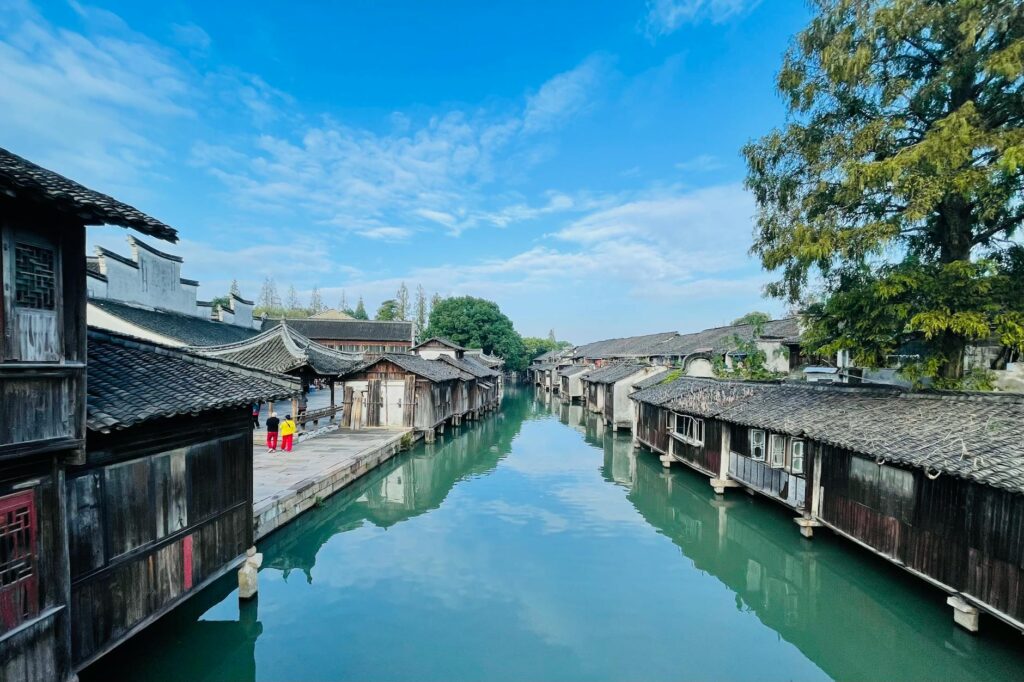 Wuzhen water town illuminated at night with reflections on calm canal waters
