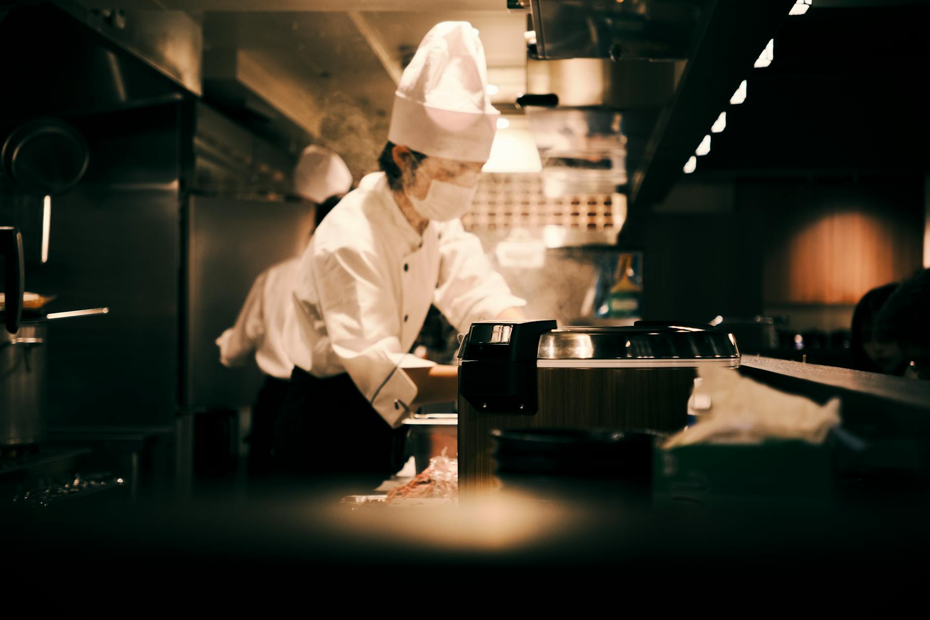 A chef working in a busy professional restaurant kitchen in Shanghai