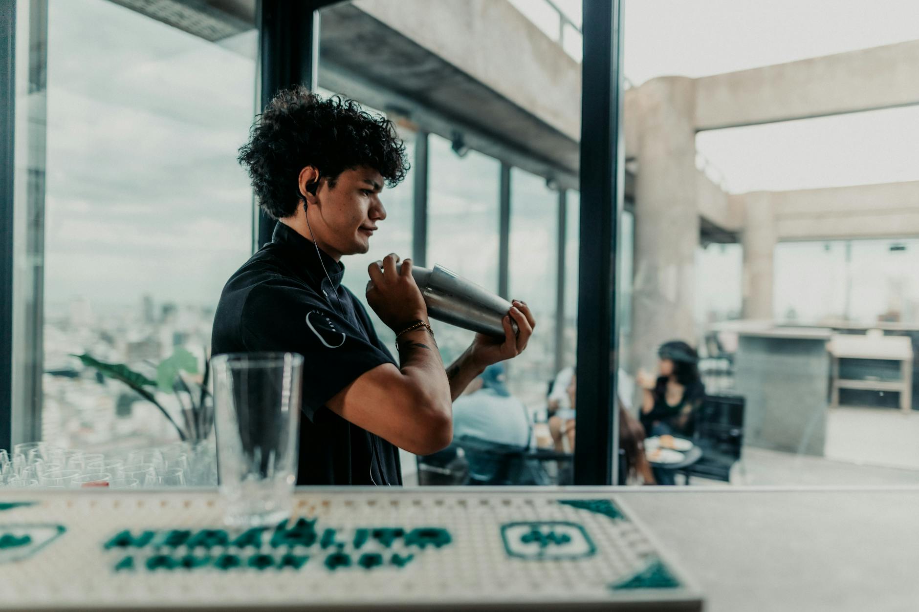 Best rooftop bars Shanghai bartender shaking cocktail at rooftop