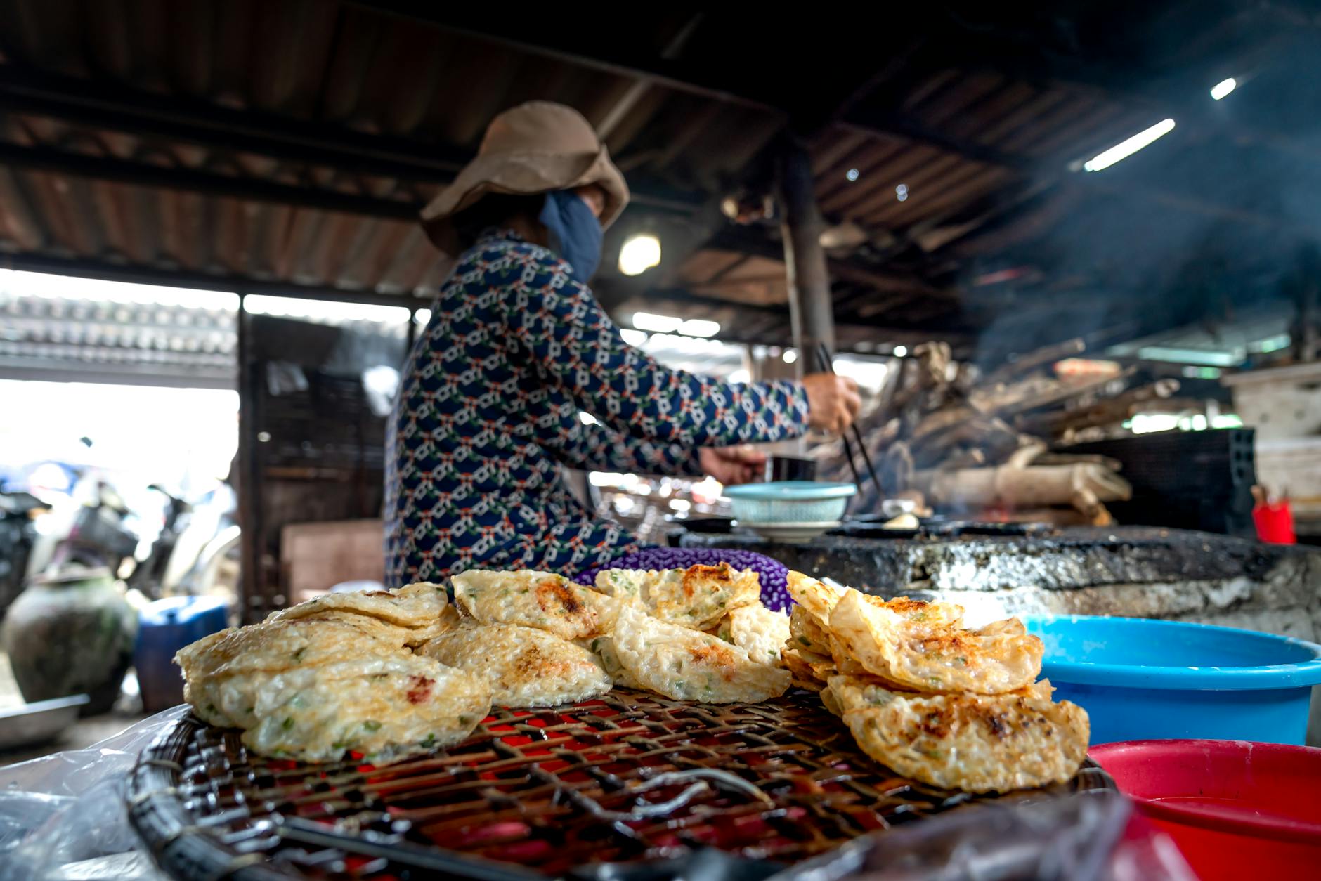 Cheap eats in Shanghai street vendor griddling pancakes at a food stall