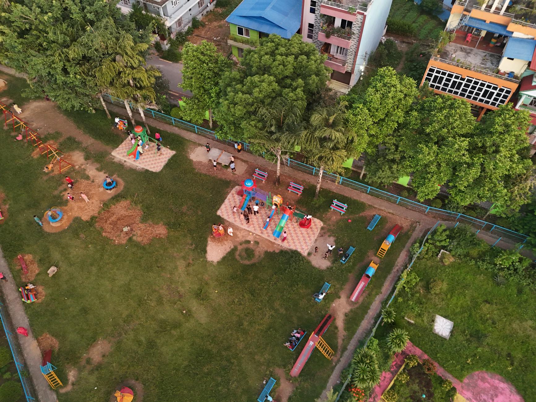 Shanghai with kids playing at a colorful playground in a city park