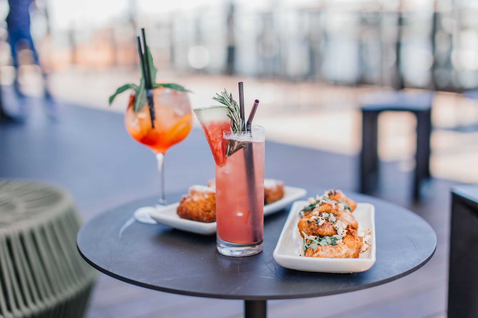 Cocktails and small plates on a rooftop bar terrace at dusk, the kind of evening the best rooftop bars in Shanghai are built around