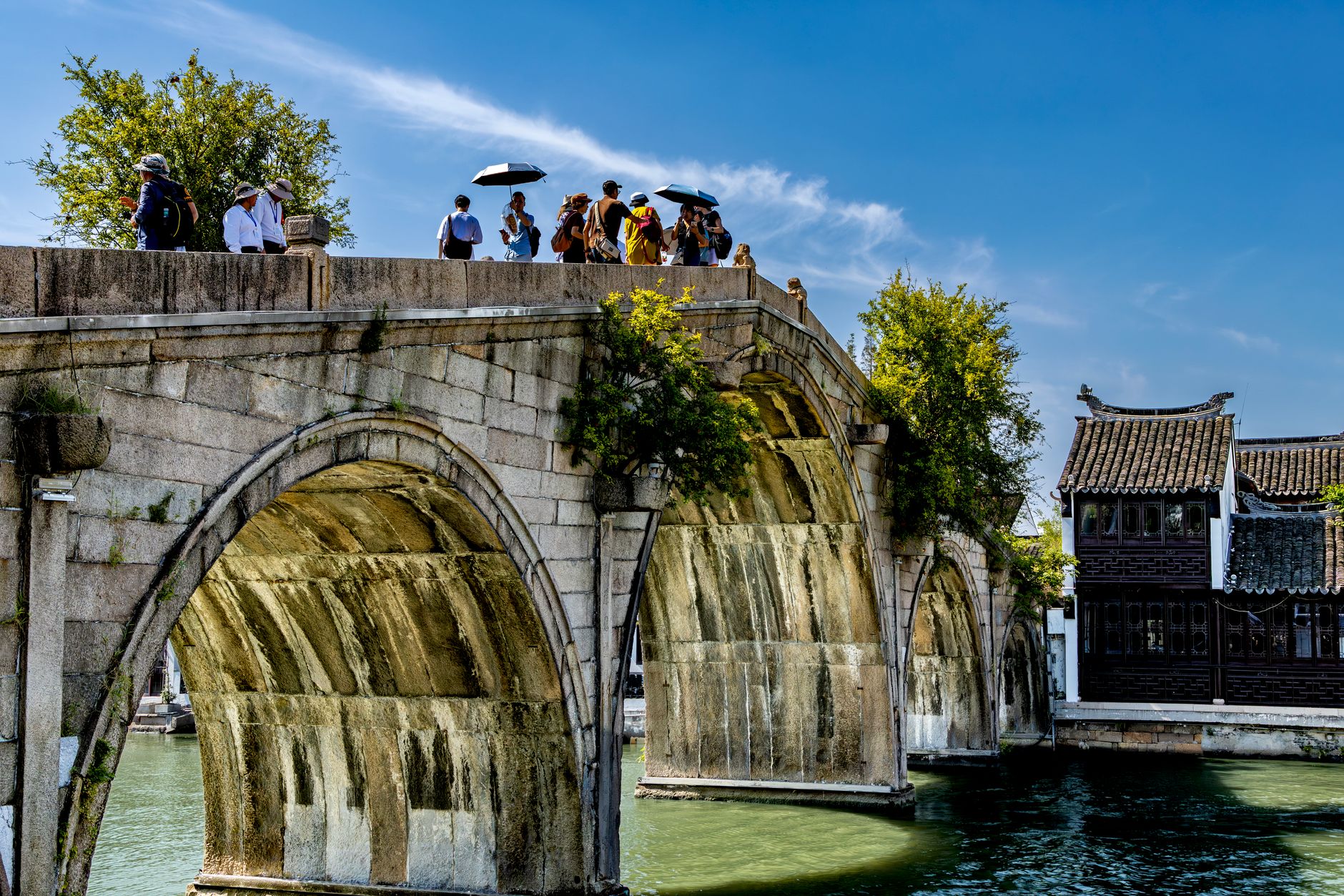 Arched stone bridge over a canal in a Chinese water town near Shanghai