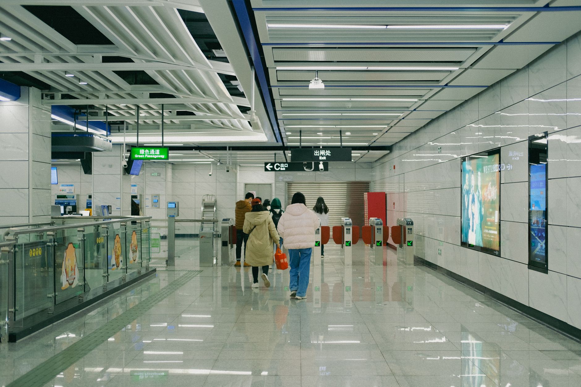 Passengers passing through metro station ticket gates