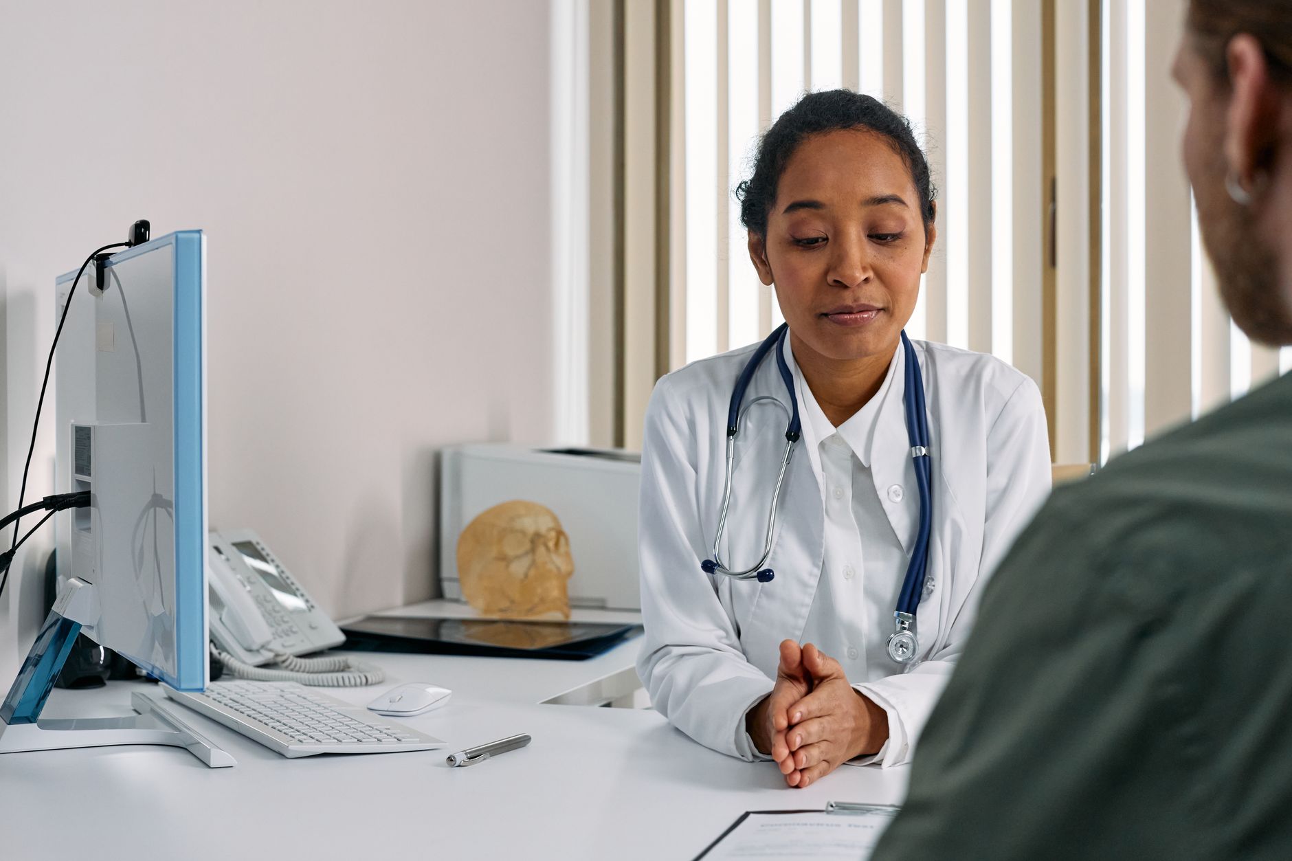 A doctor consulting with a patient in a modern medical office