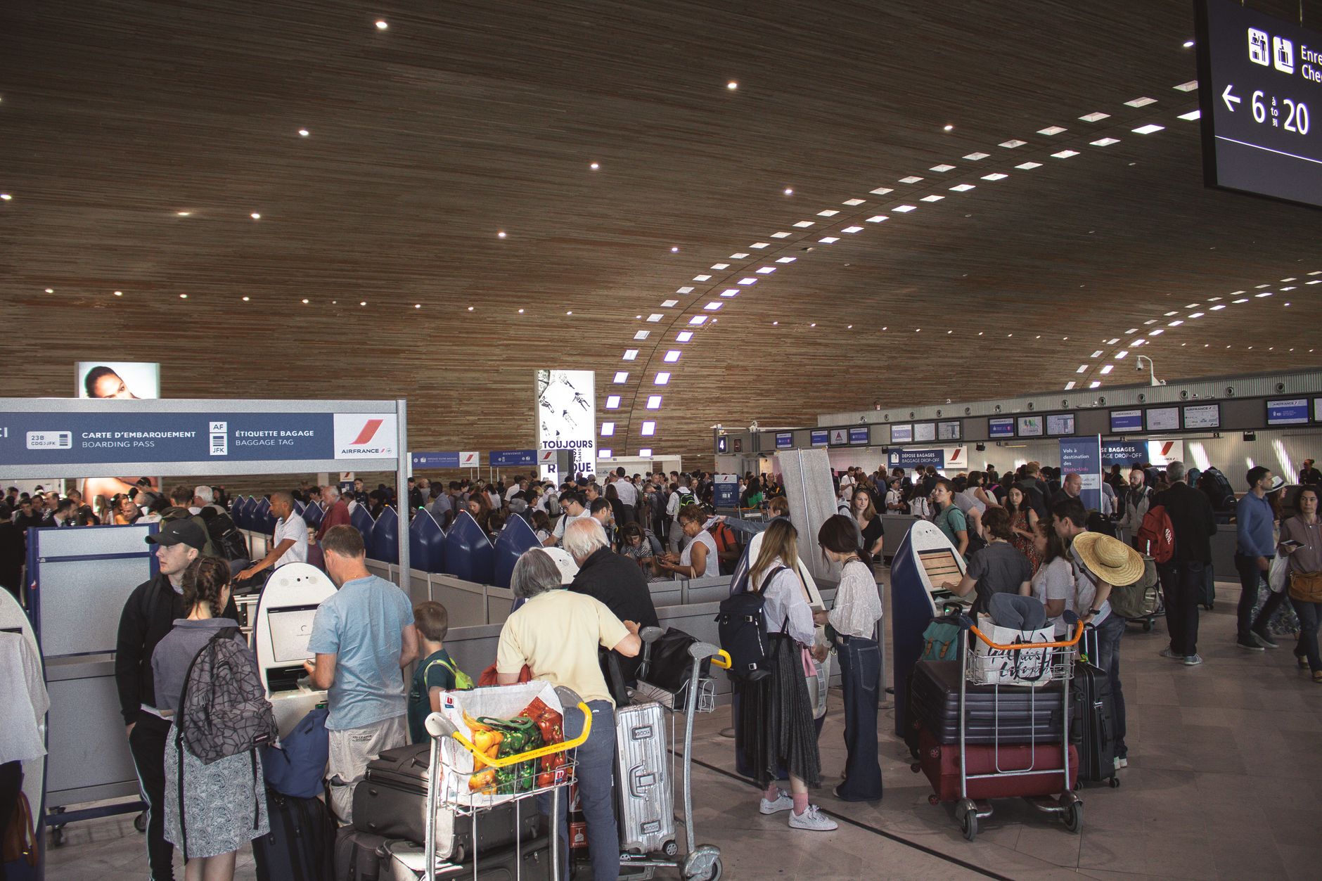 Travellers queuing in an airport arrivals hall, where the SIM card counters at Shanghai Pudong are located