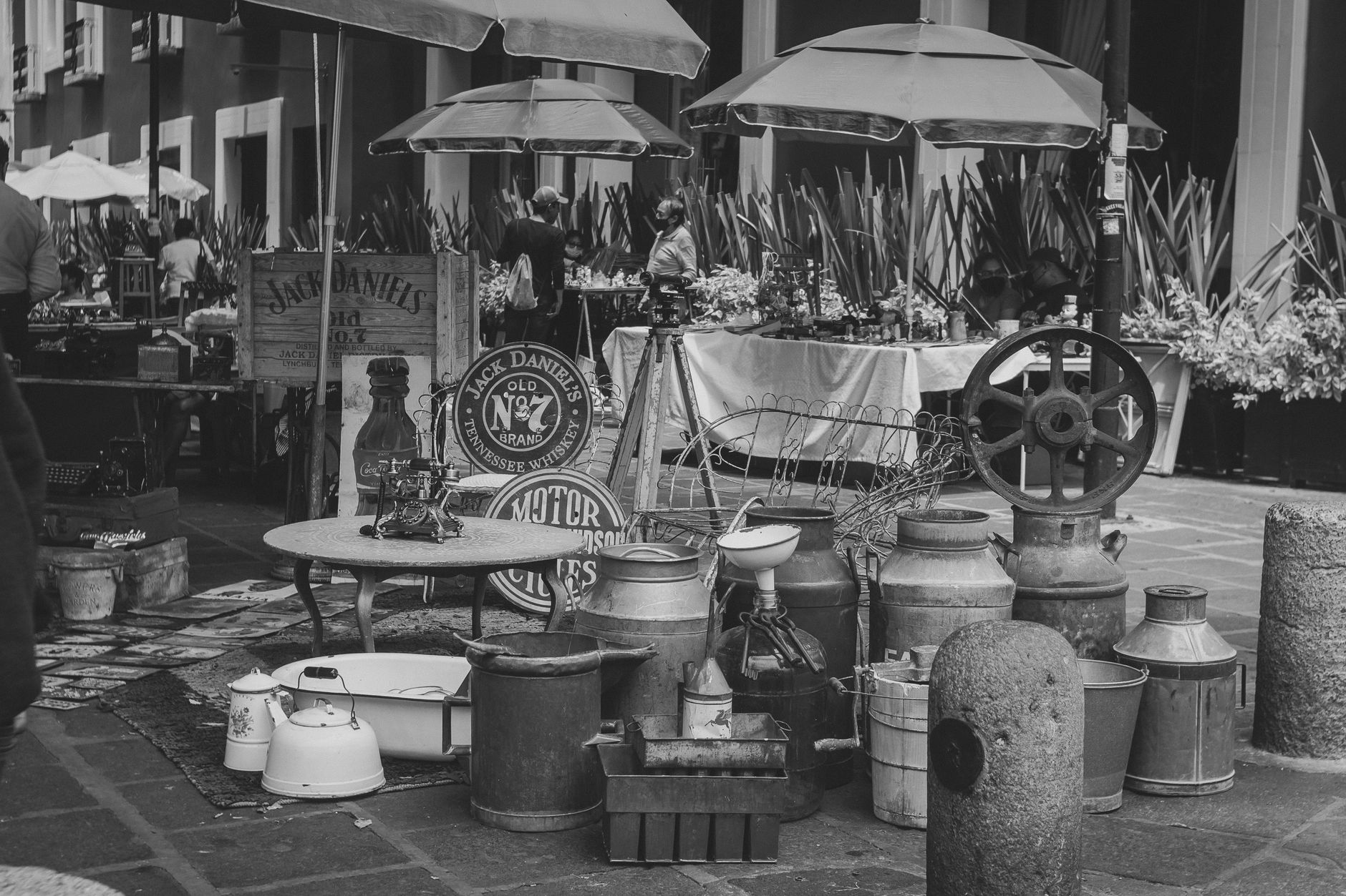 An antique stall piled with old objects at a weekend flea market