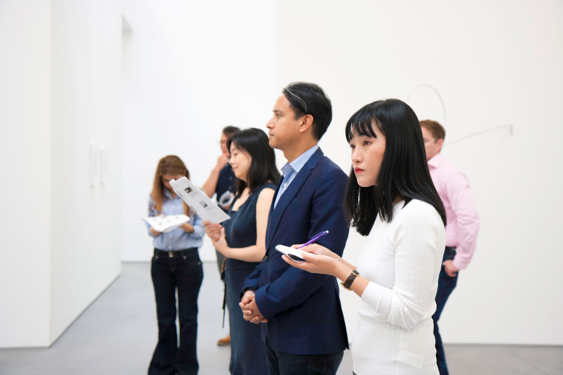 Visitors looking at contemporary art installations in a modern gallery