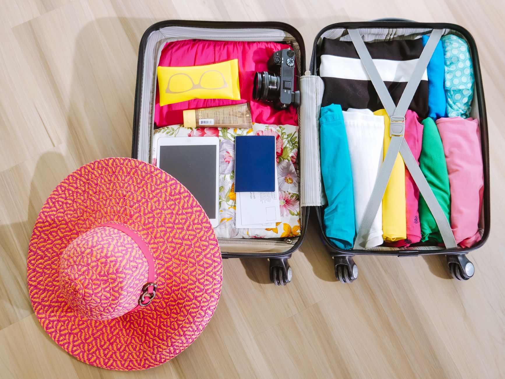 An open suitcase packed with clothes and a camera, the kind of personal effects allowed into China