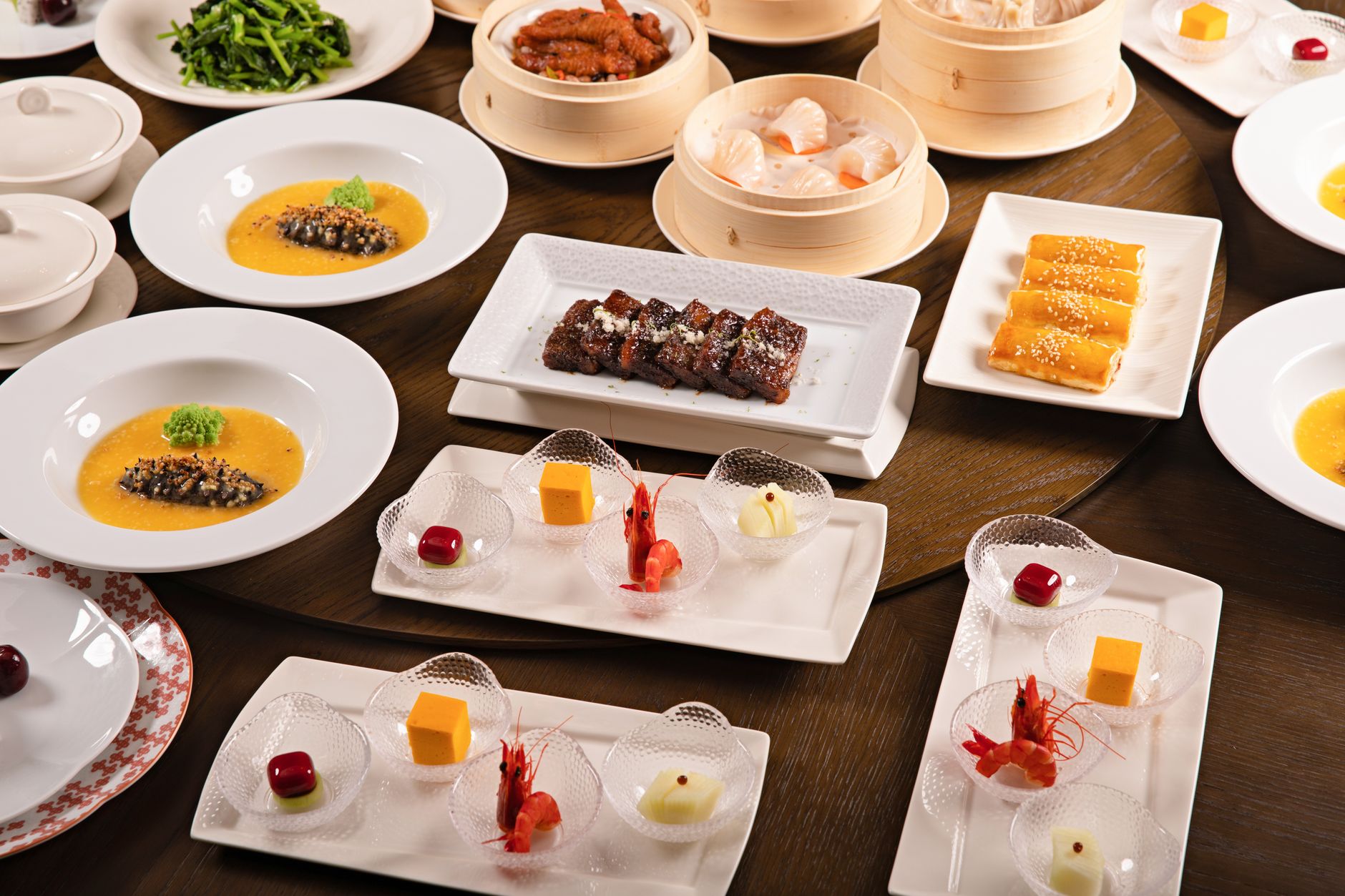 A spread of Chinese dishes arranged on a round table for shared family-style dining