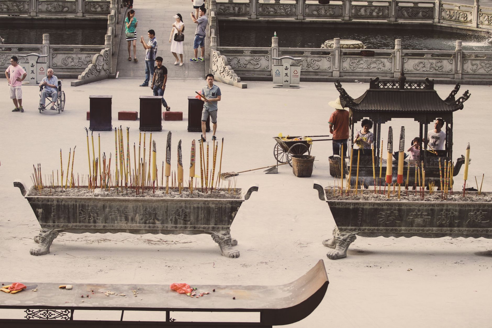 People holding incense sticks during a traditional ceremony at a Chinese temple