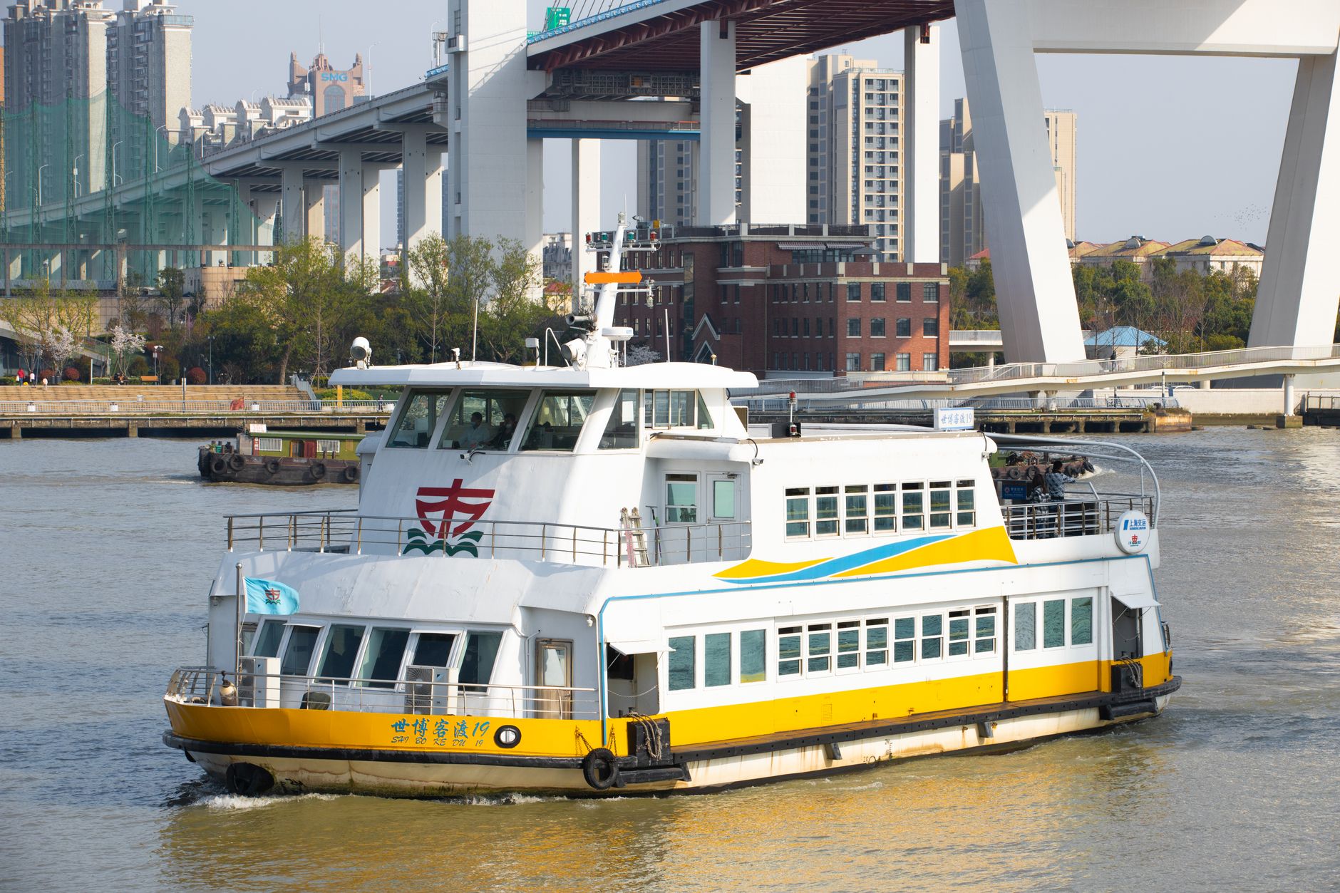 A passenger ferry crossing the Huangpu River in Shanghai with the city skyline behind it