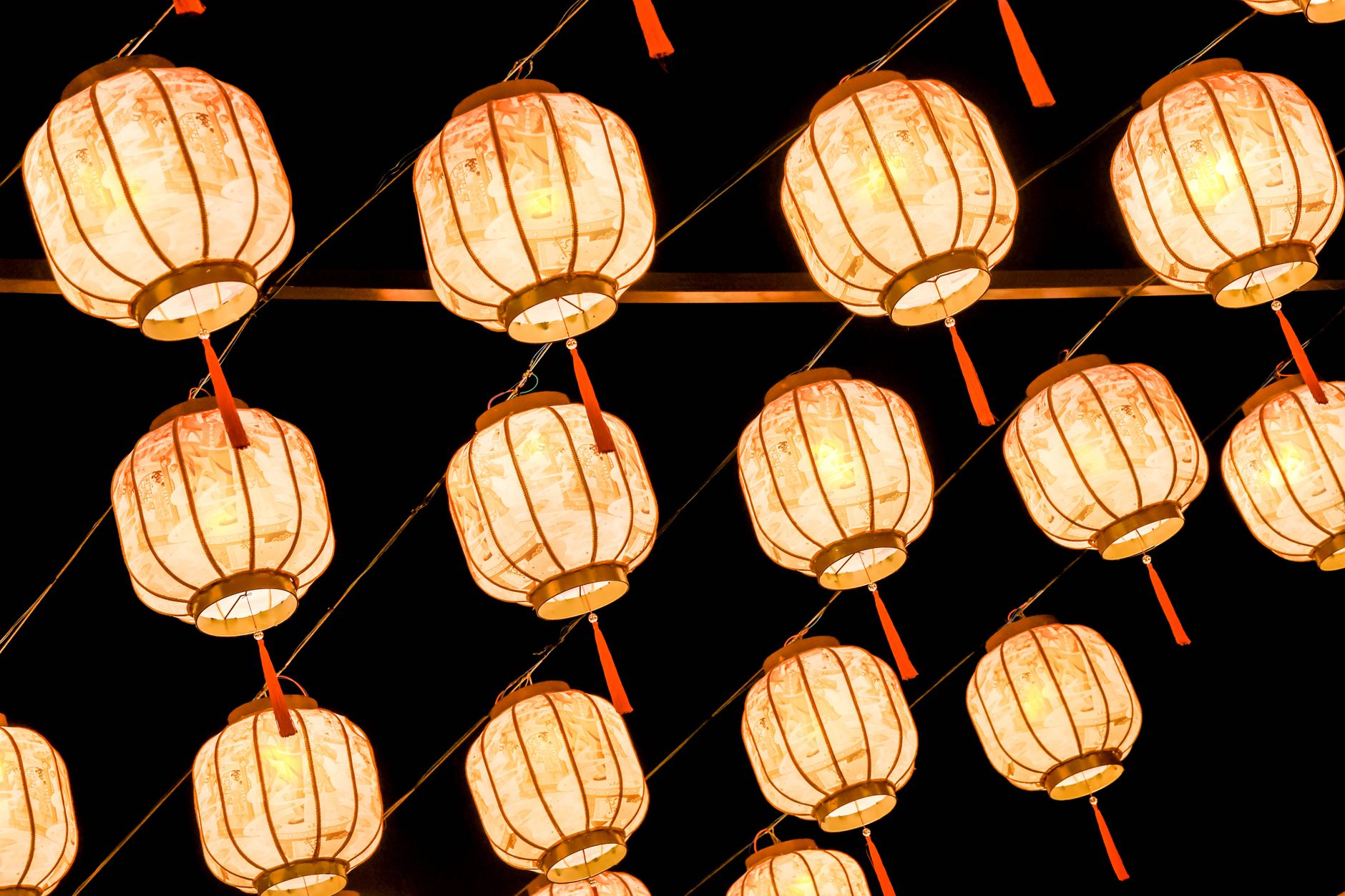Rows of red Chinese lanterns lit up after dark during a lunar new year festival