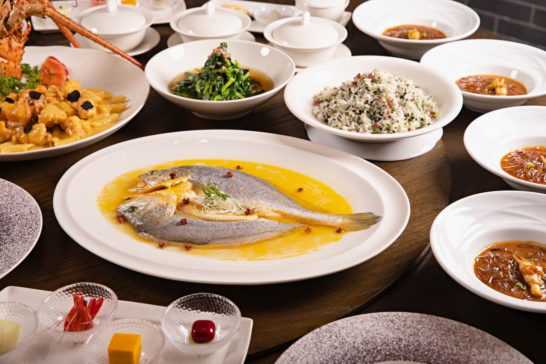 A Chinese banquet table laid with seafood dishes for a group dinner