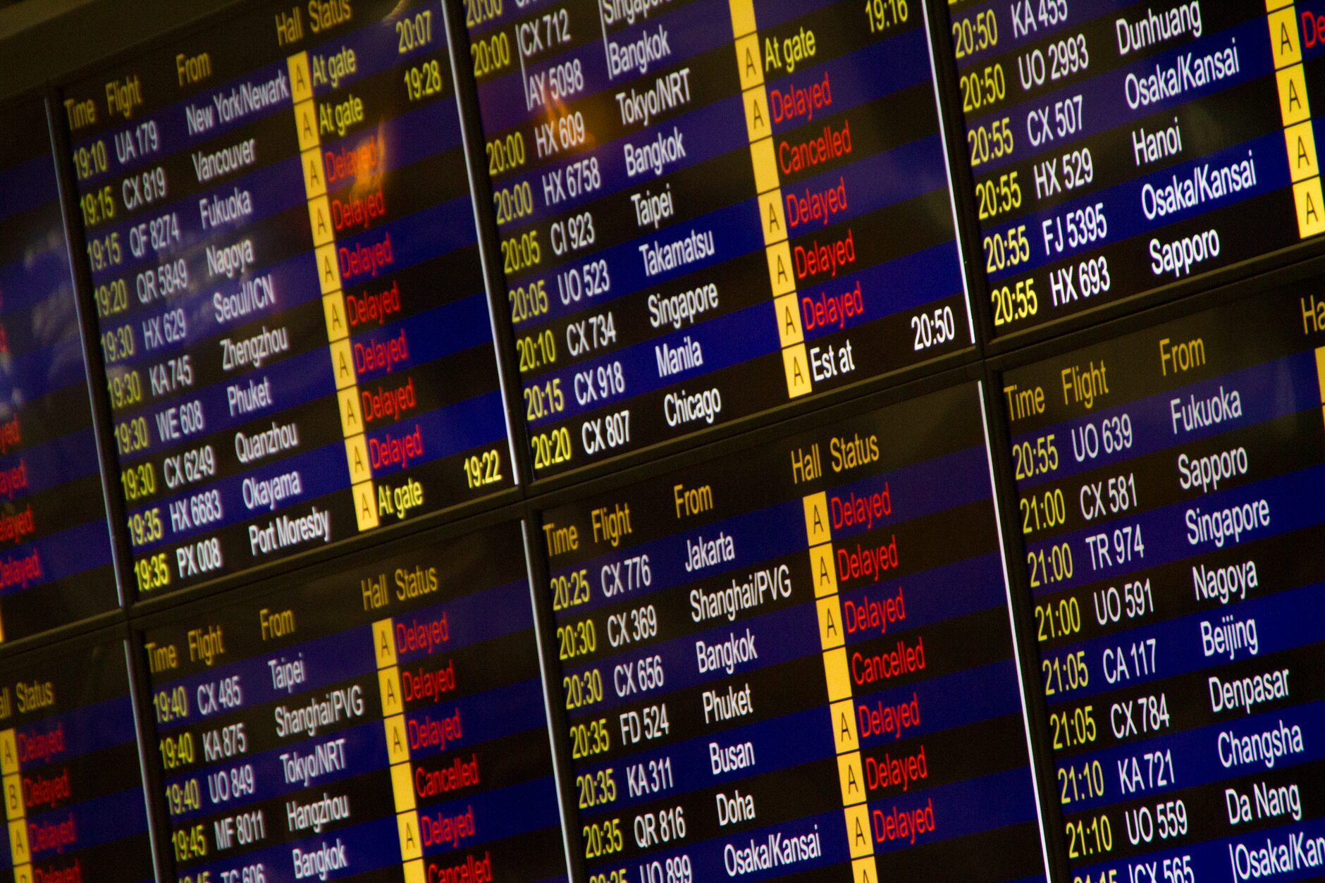 A digital flight information board showing departures during an airport layover