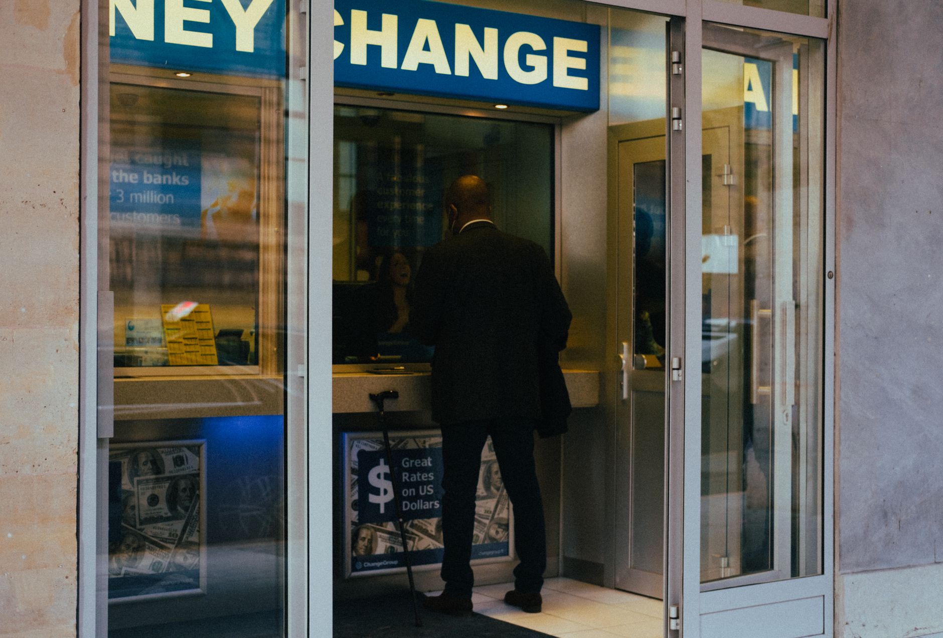 A traveller changing foreign money at a currency exchange counter