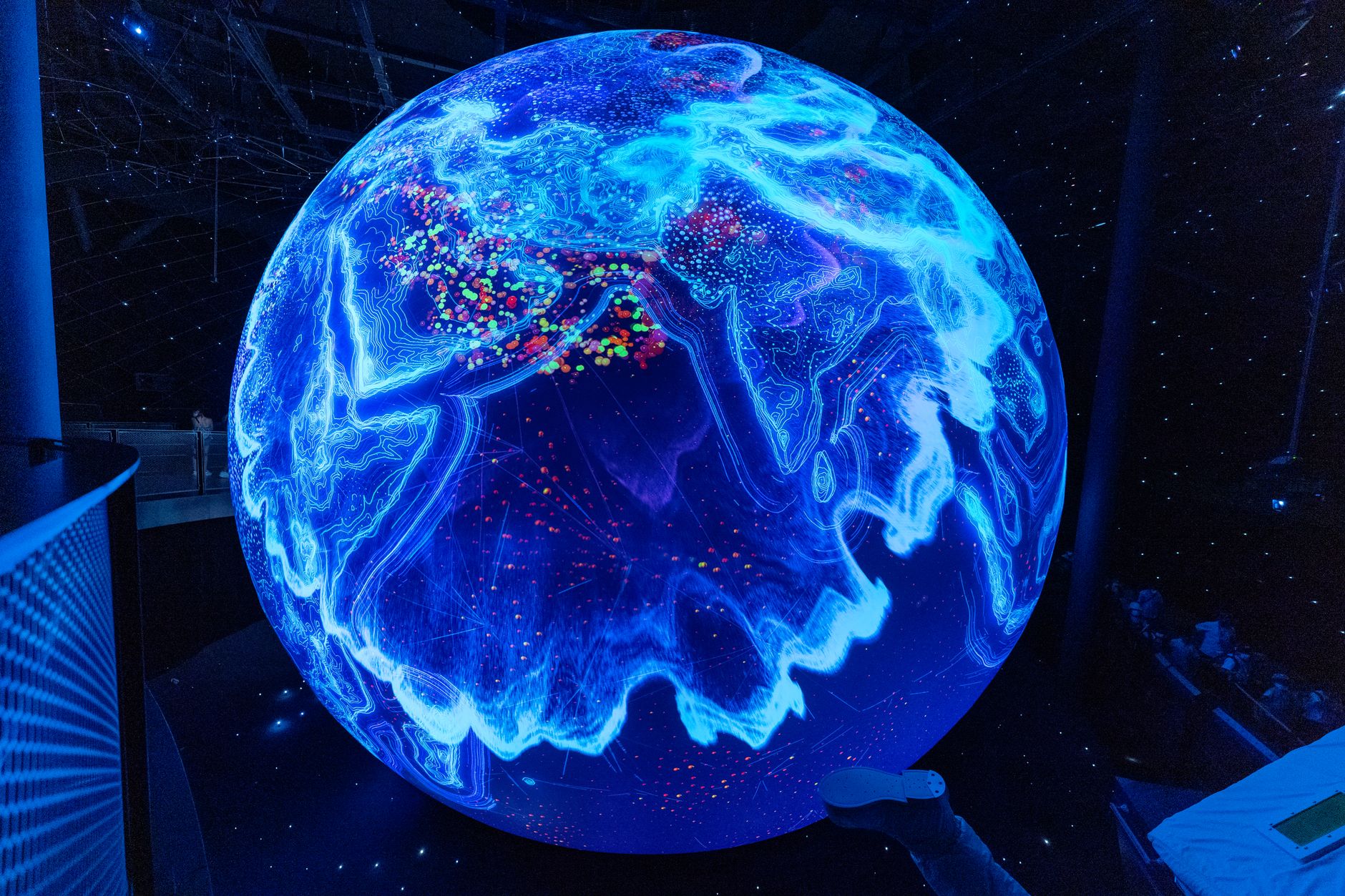 An illuminated globe display in a science museum gallery about the planet and its ecosystems