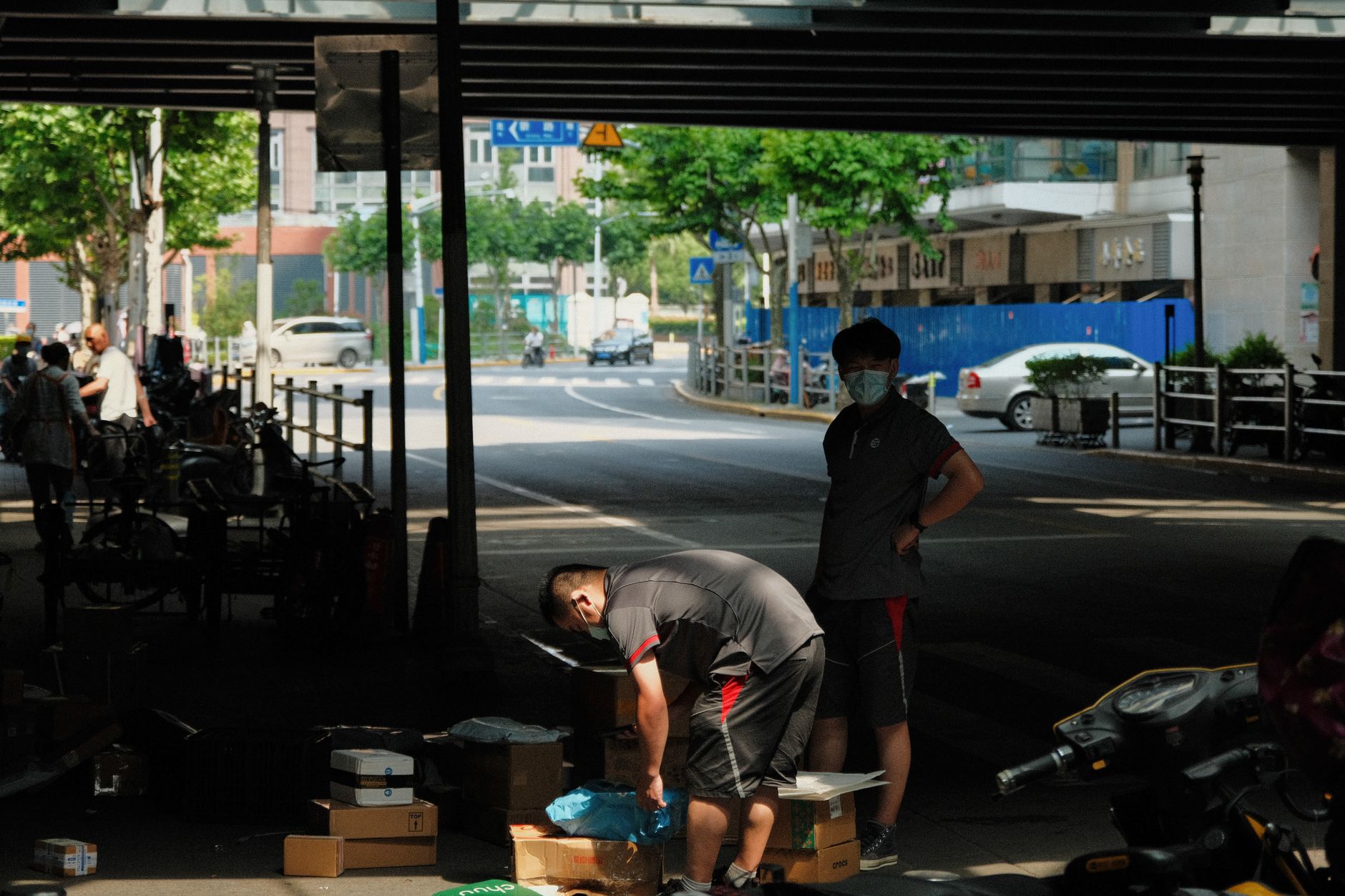 Street vendors working on a pavement in Shanghai where little English is spoken