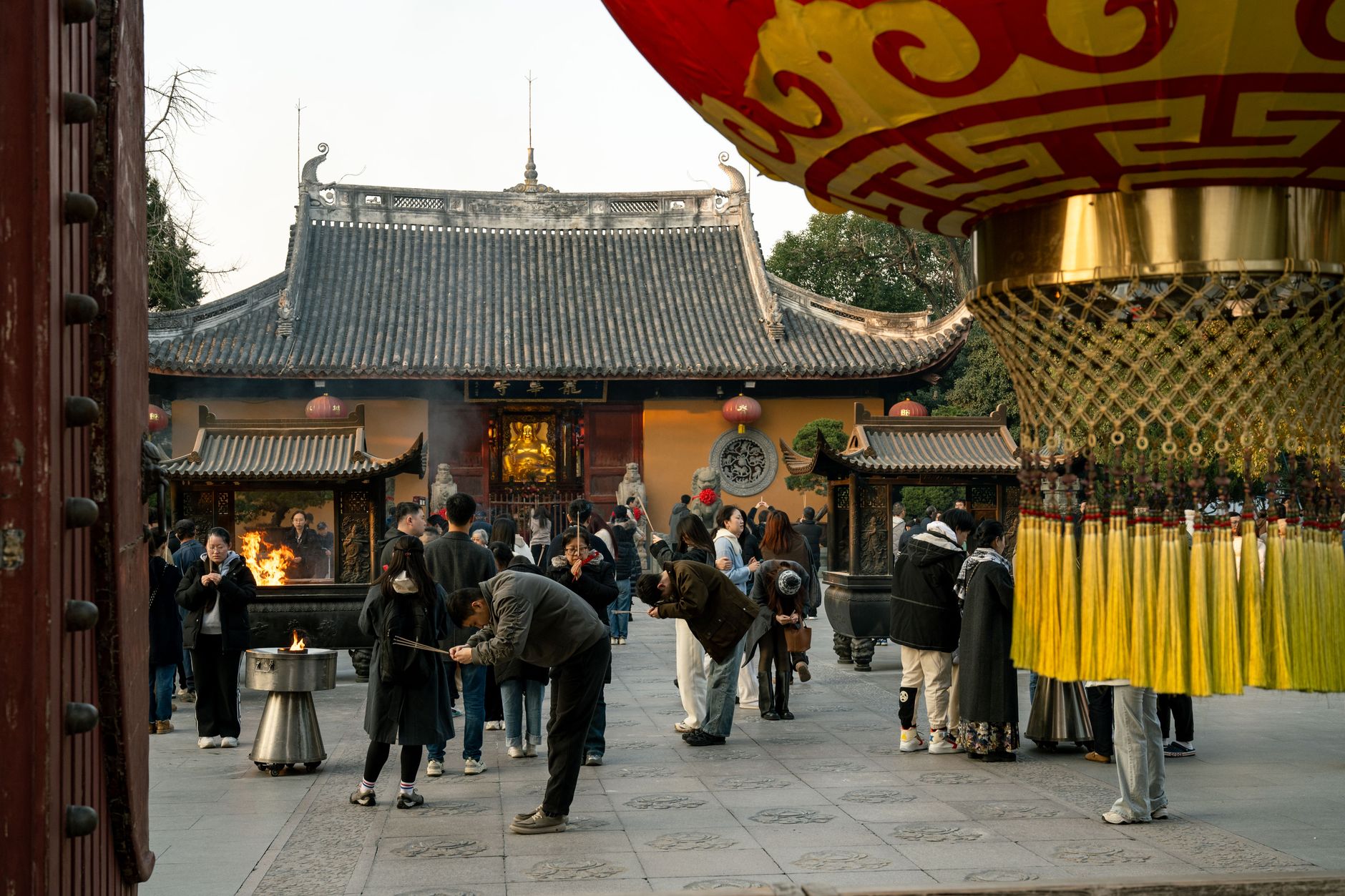 Worshippers with incense in a temple courtyard in Shanghai