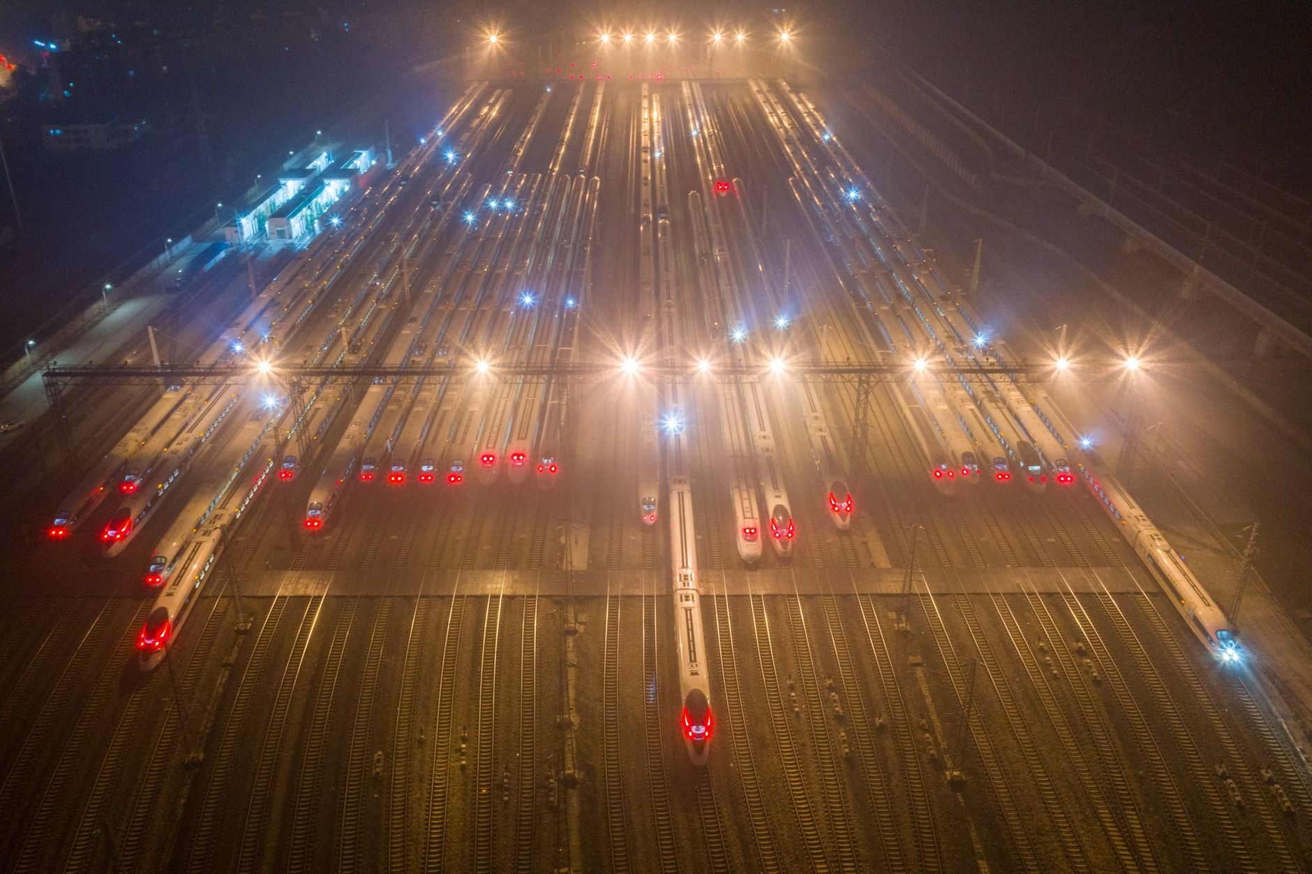 High-speed trains lined up at a railway station in Nanjing at night