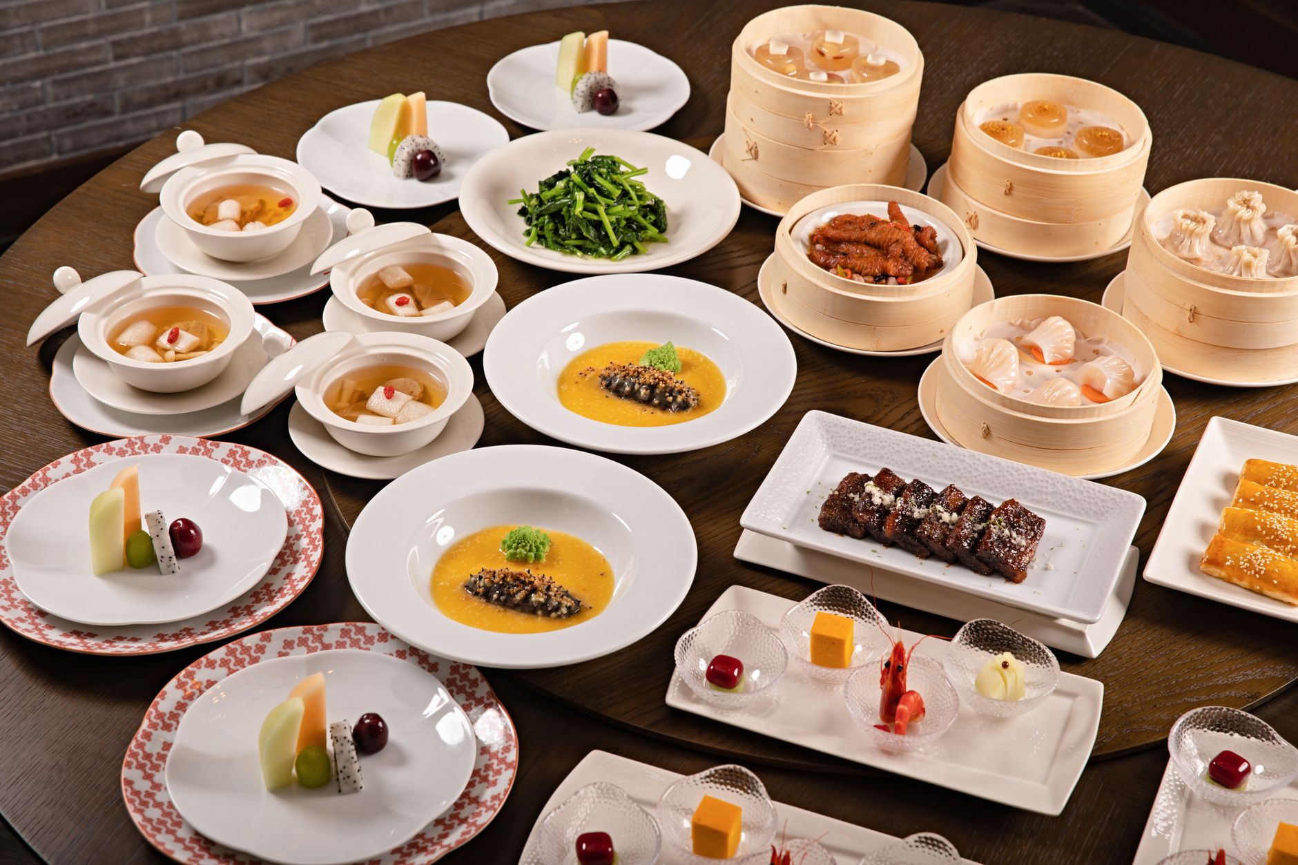 A spread of Chinese dishes laid out across a table for a shared family-style meal