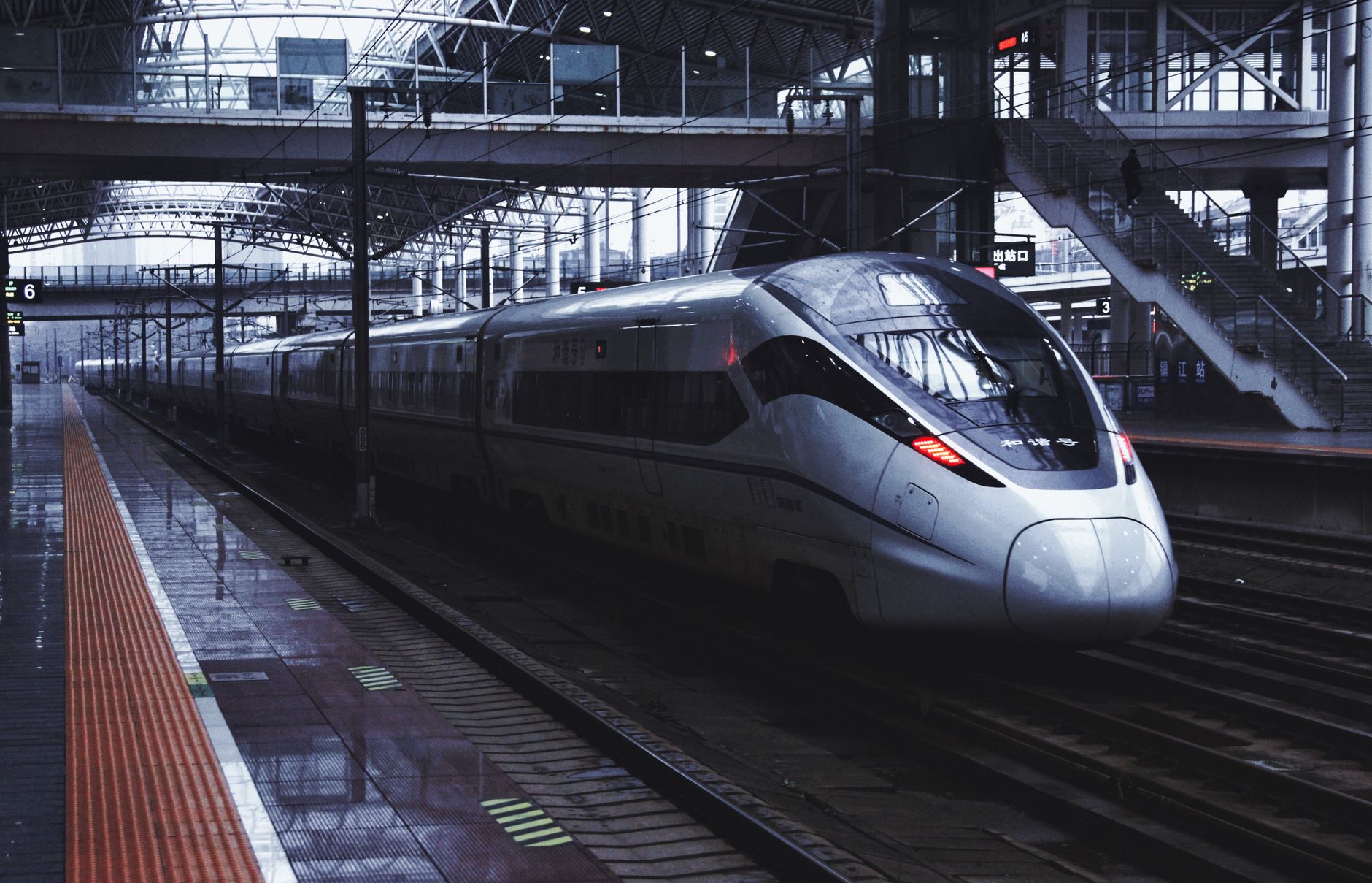 A Chinese high-speed train waiting at a station platform before departure
