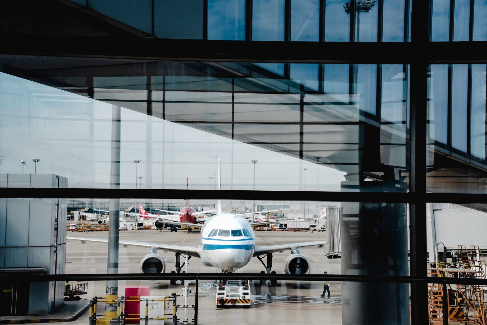 A domestic airliner at the gate seen from a Shanghai airport terminal window