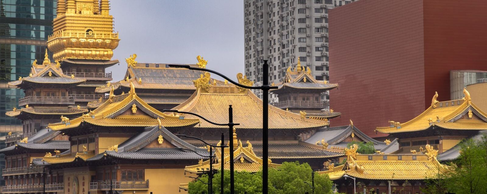 Golden roofs of Jing'an Temple surrounded by skyscrapers in Jing'an District, Shanghai