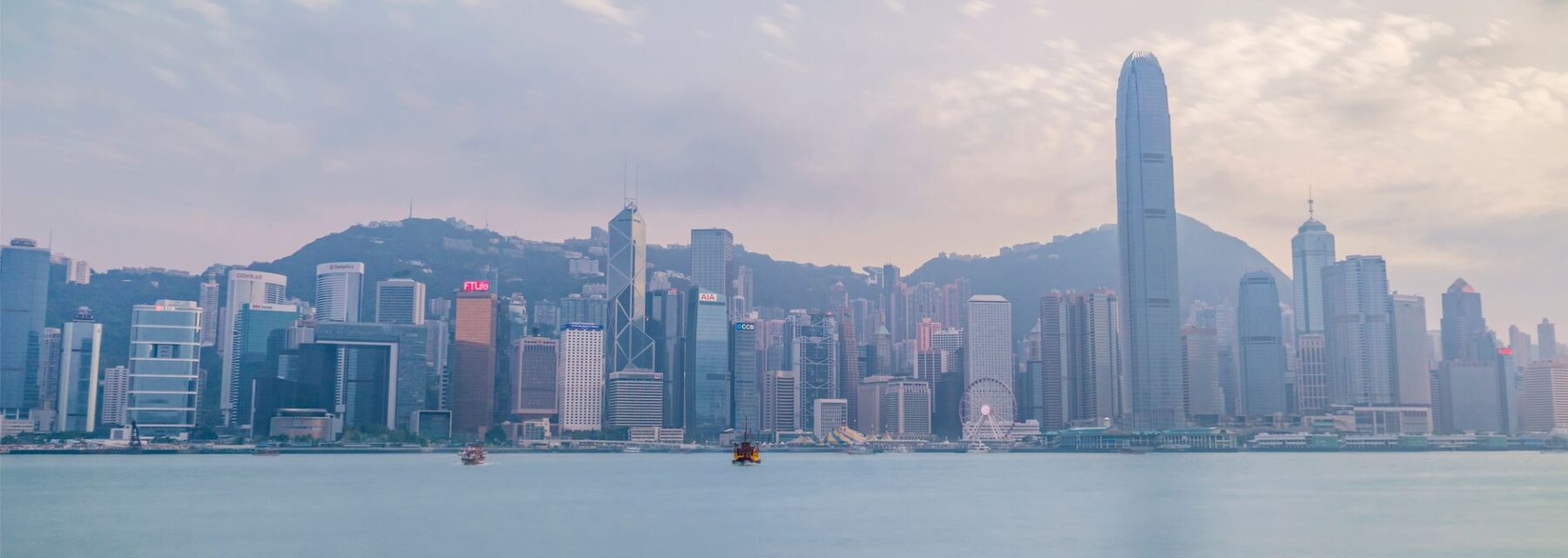 The Hong Kong skyline seen across Victoria Harbour at dusk