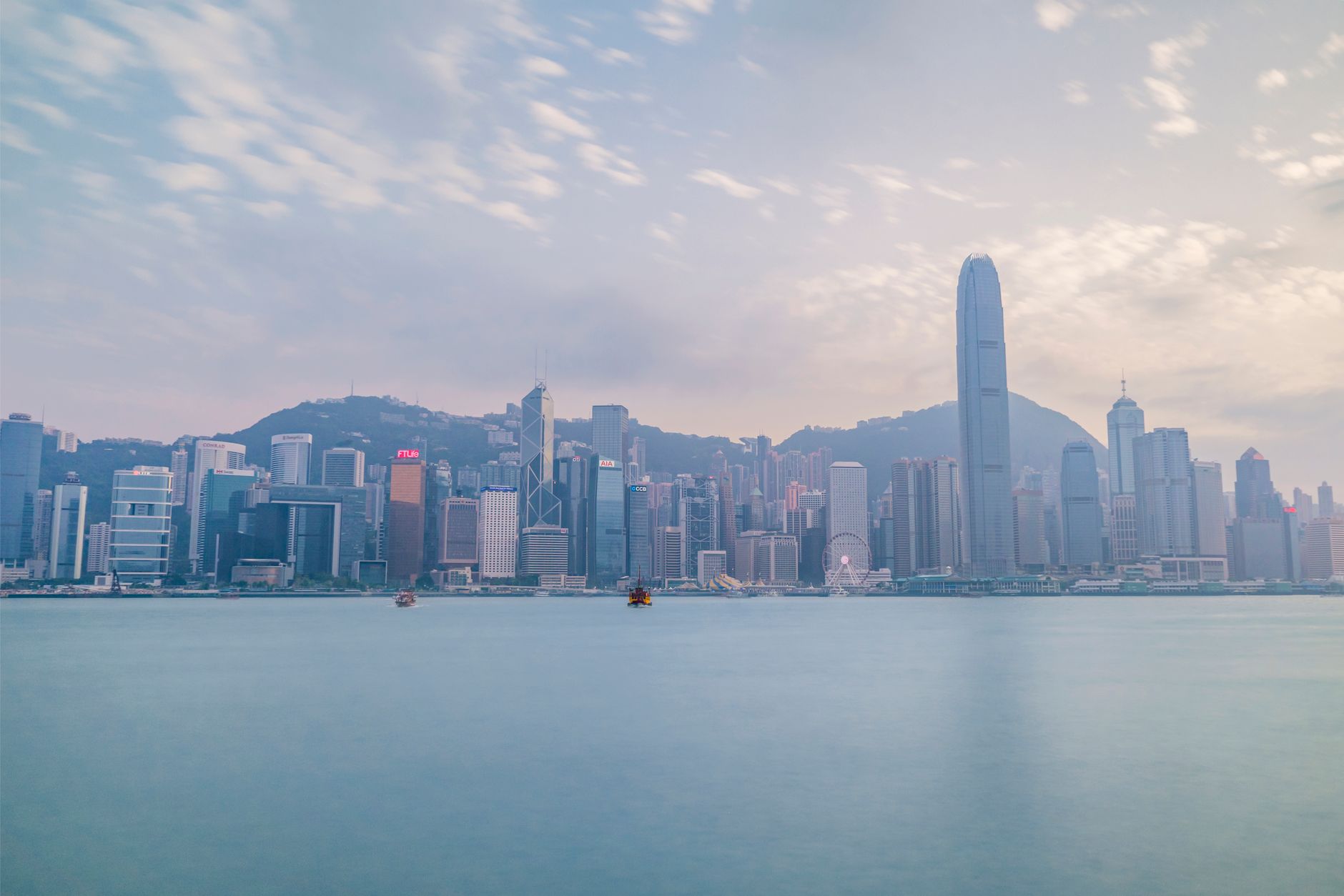 The Hong Kong skyline seen across Victoria Harbour at dusk