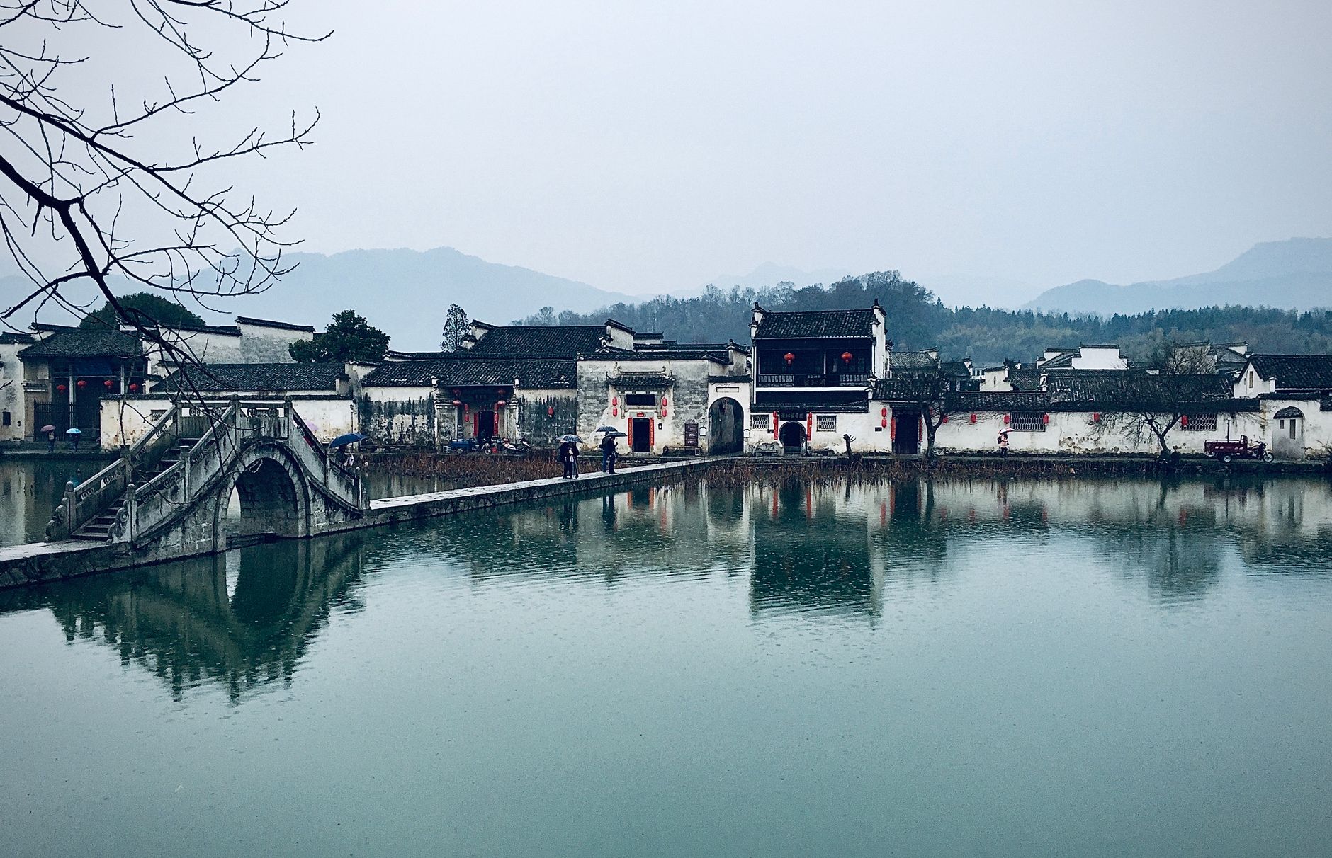 A Huizhou village of whitewashed walls and black tiled roofs reflected in a still lake