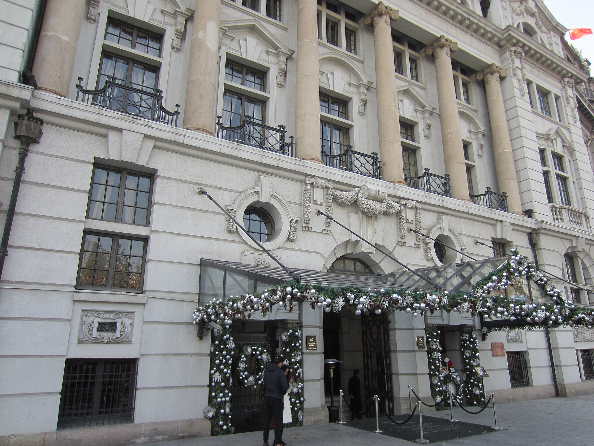 Christmas garlands and wreaths around the entrance of the Waldorf Astoria on the Bund